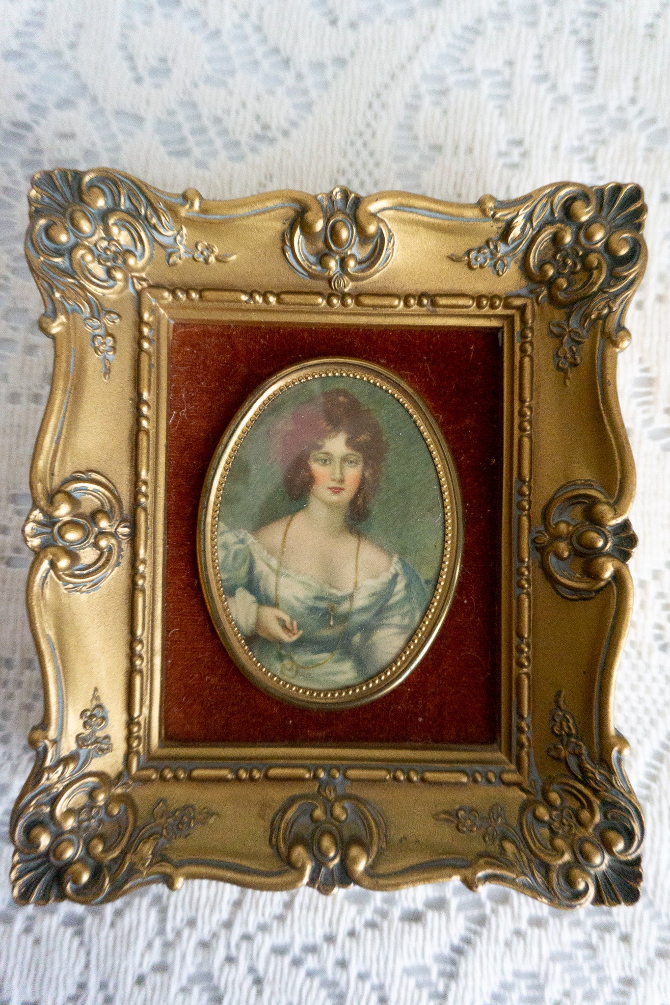 Cameo Creation wall art featuring 'Mrs. Croker' by Vincent Nesbert in a gold baroque-style frame with a rust velvet backdrop.