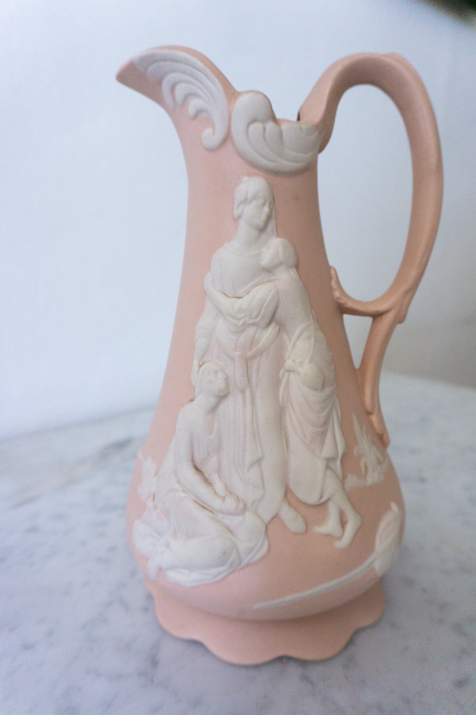 Side view of pink jasperware pitcher with classical figures