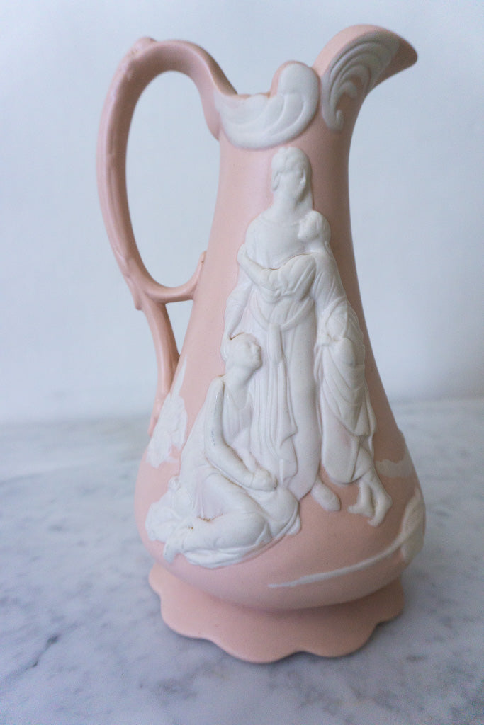 Detailed close-up of white relief on pink jasperware pitcher