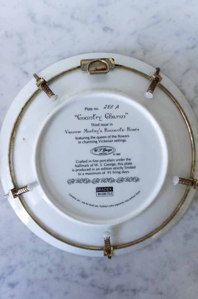 Back of "Country Charm" plate showing markings and plate hanger