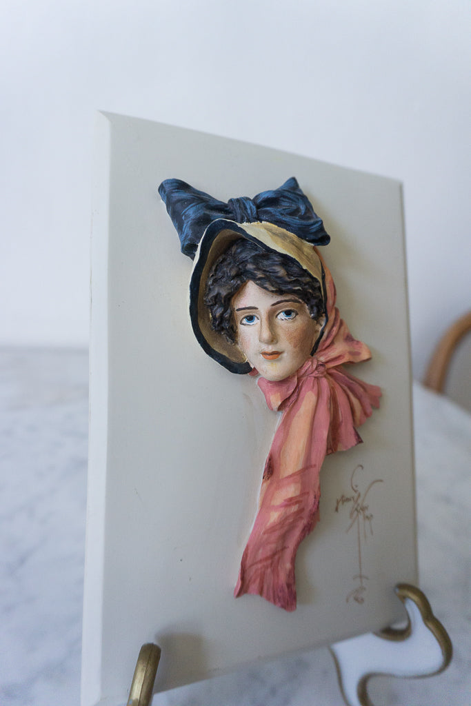 Side view of the "Anna" wall plaque, showcasing the detailed hand-painted features.