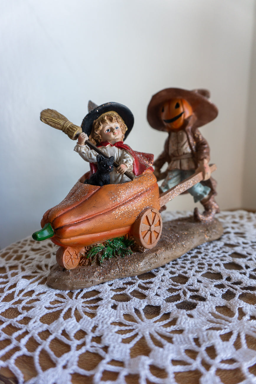 Scarecrow and Child in Wheelbarrow Figurine