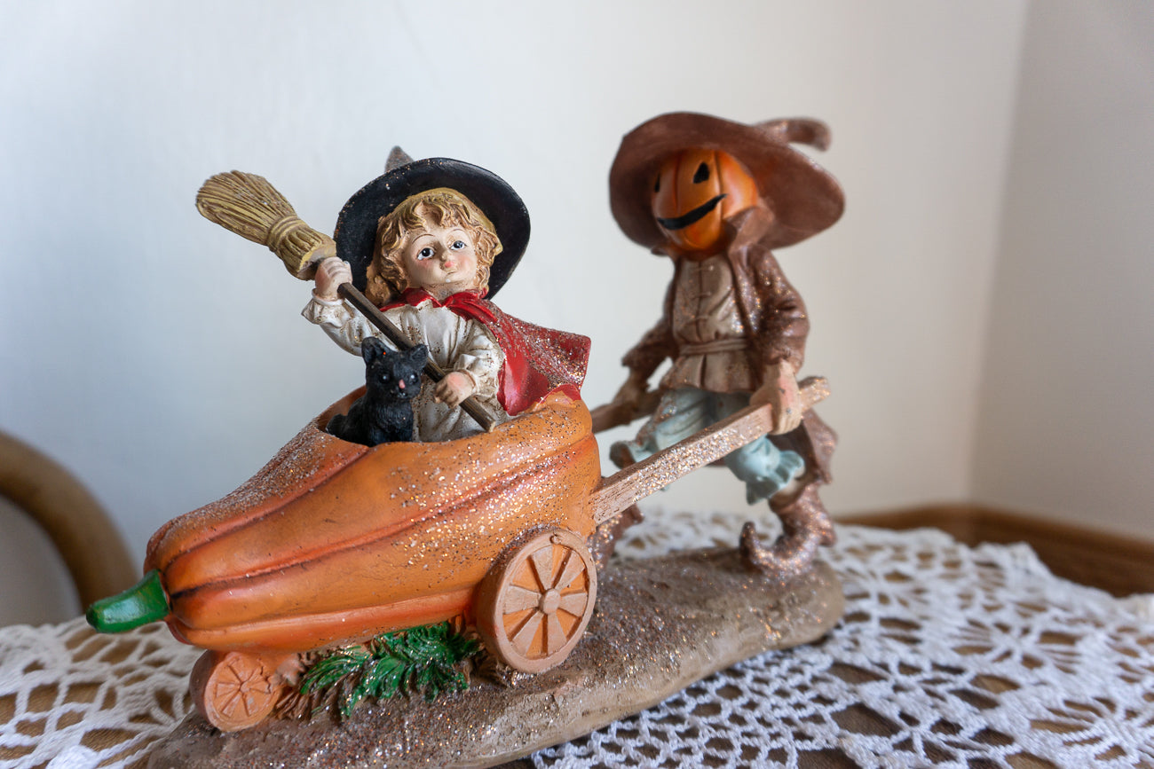 Scarecrow and Child in Wheelbarrow Figurine
