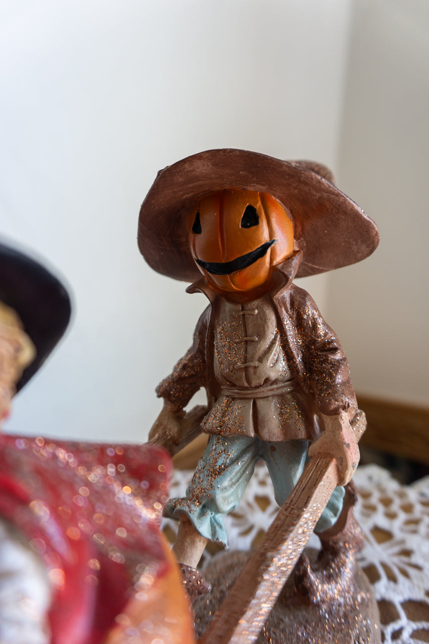 Scarecrow and Child in Wheelbarrow Figurine