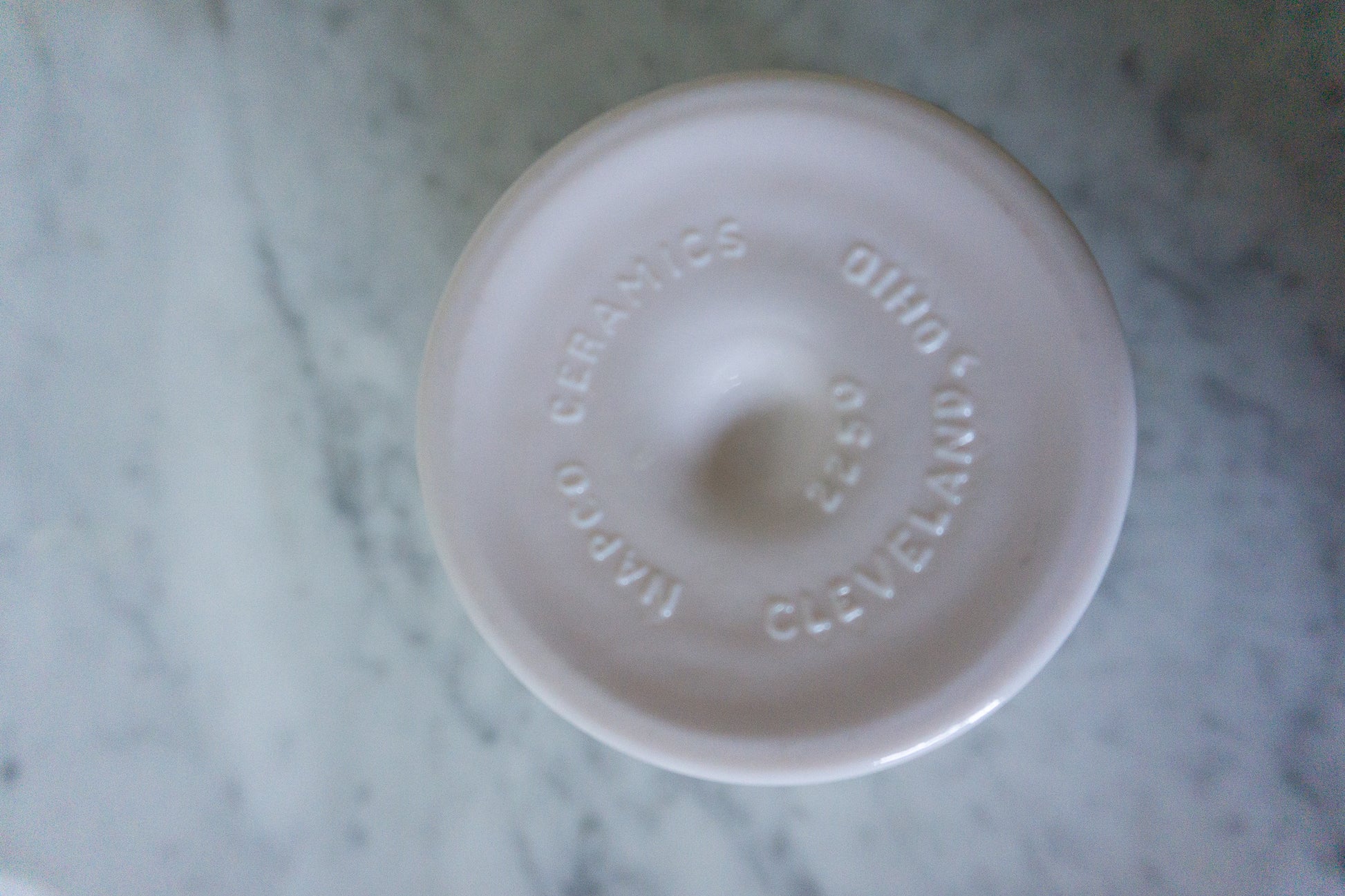 Bottom view of the Napco Ceramics mark on the pink milk glass pedestal dish