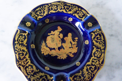 Detailed view of the gilded floral patterns on the Limoges ashtray.