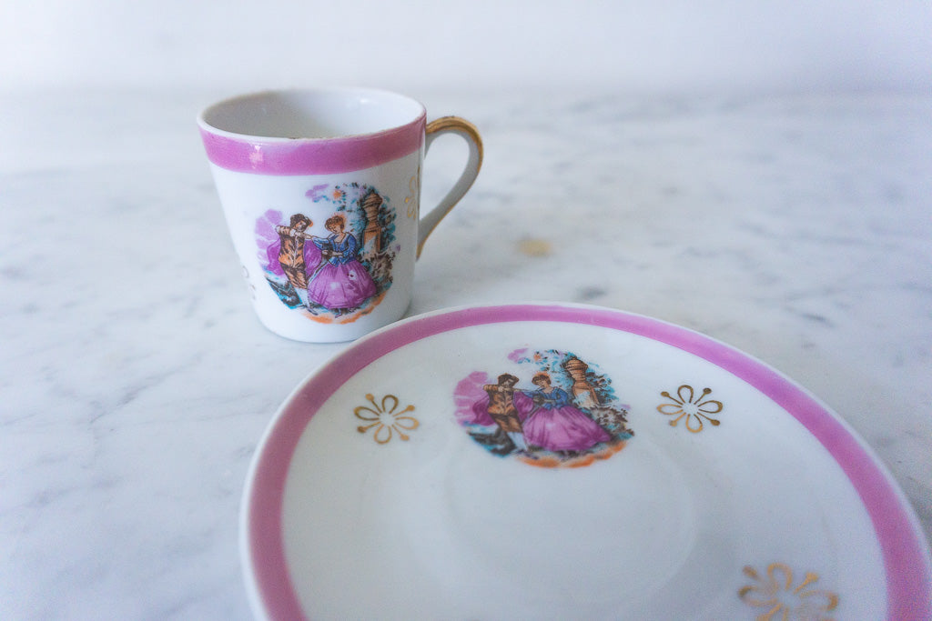 Side view of the pink Victorian cup with saucer in the background