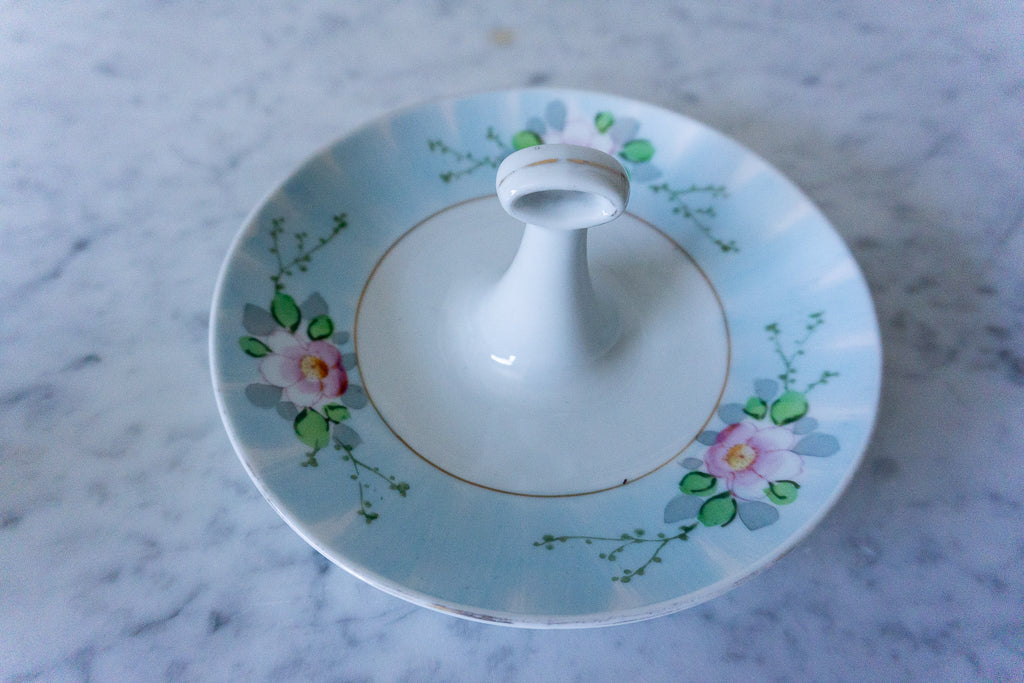 Top view of a vintage hand-painted porcelain lemon slice server with delicate floral design