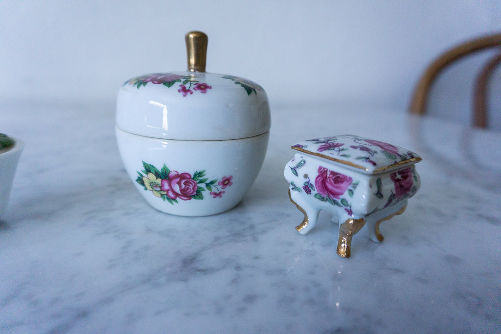 Apple-shaped trinket box with gold-tone lid and pink roses.