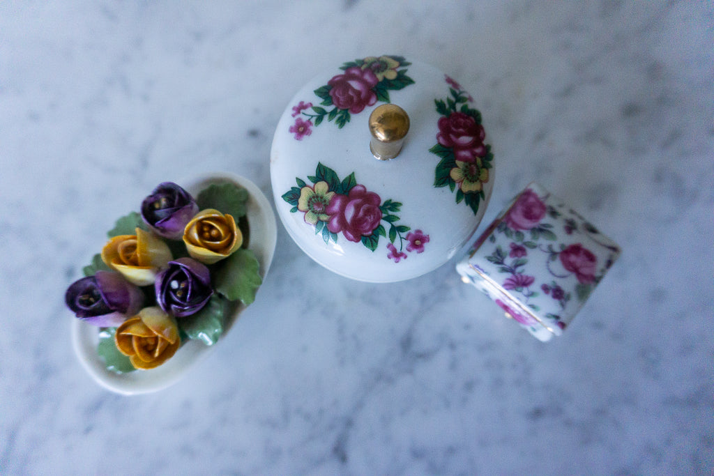 Overhead view of the porcelain trinket boxes and flower arrangement.