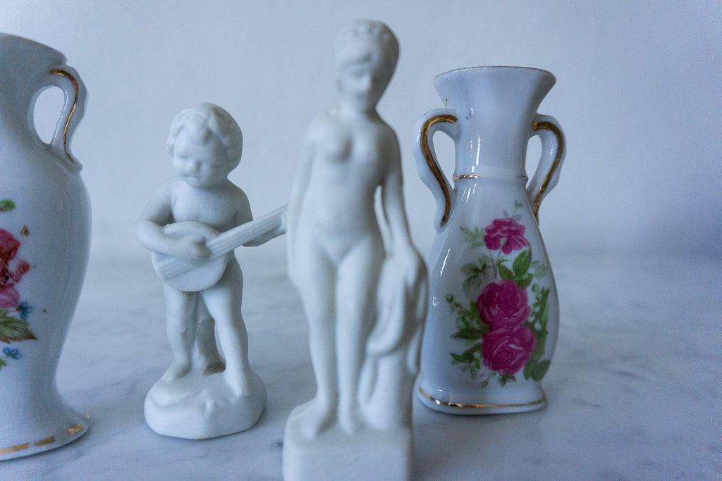 Detailed view of boy playing guitar porcelain figurine