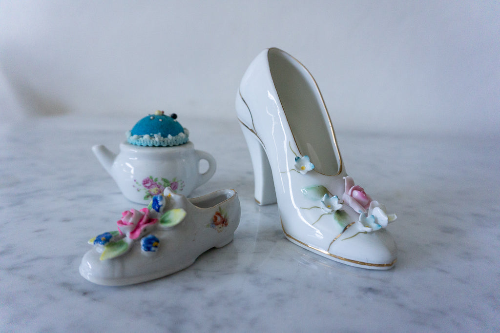 Close-up of teapot pincushion with blue cushion