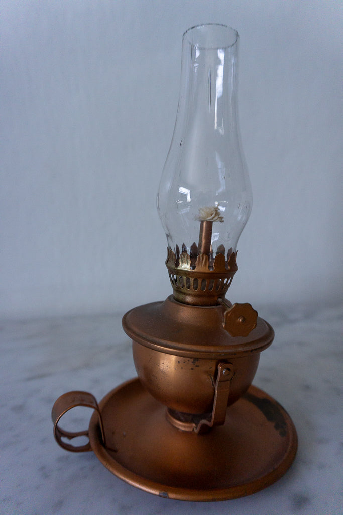 Close-up of copper finish miniature lamp showing the detailed chimney and base.