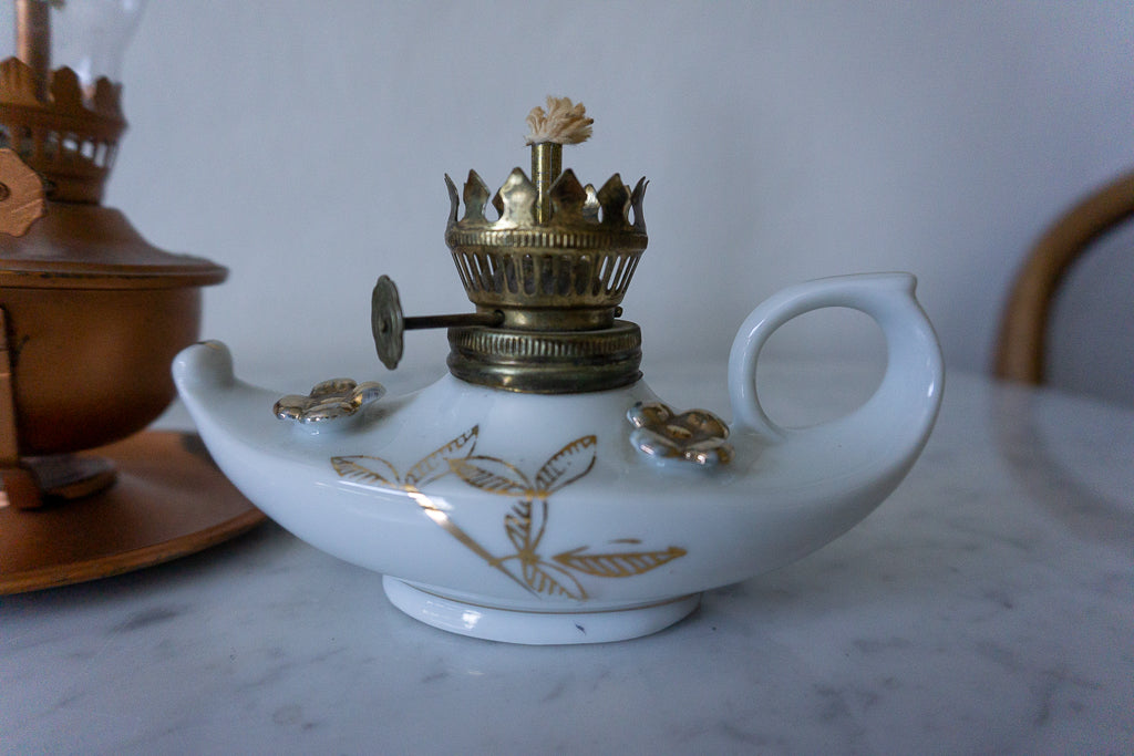 White porcelain lamp adorned with gold floral accents and marked "Made in Japan"