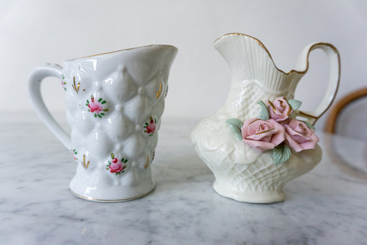 Pair of floral pitchers, one with quilted diamond pattern and pink roses, and the other with crafted rose arrangement