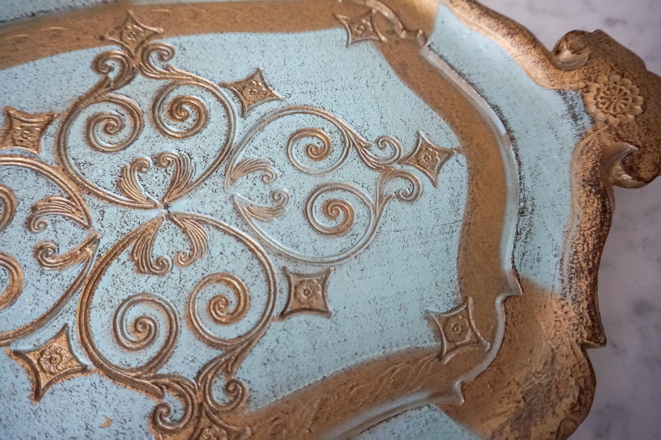 Close-up of the detailed blue and gold pattern on the Florentine tray.