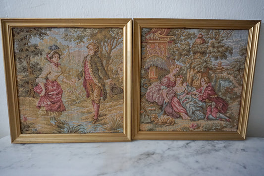 Set of two framed vintage French-style tapestry artworks depicting romantic pastoral scenes.