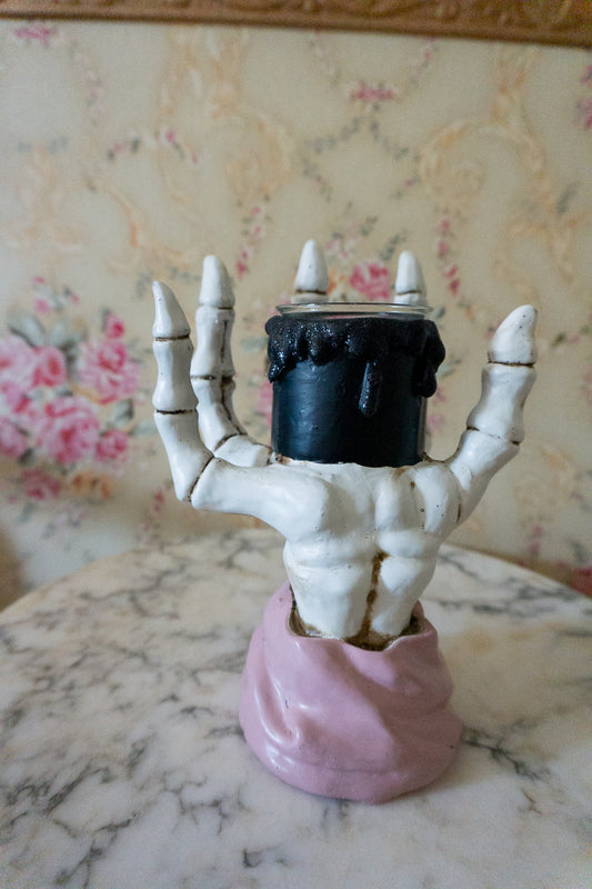 pink witch skeleton hand candle holder