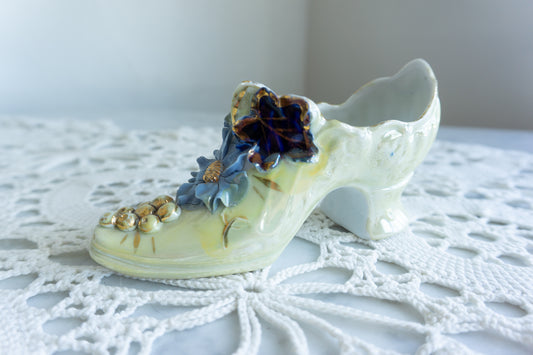 Porcelain decorative shoe with iridescent glaze, blue floral embellishments, and gold accents – vintage-style tabletop decor made in Germany